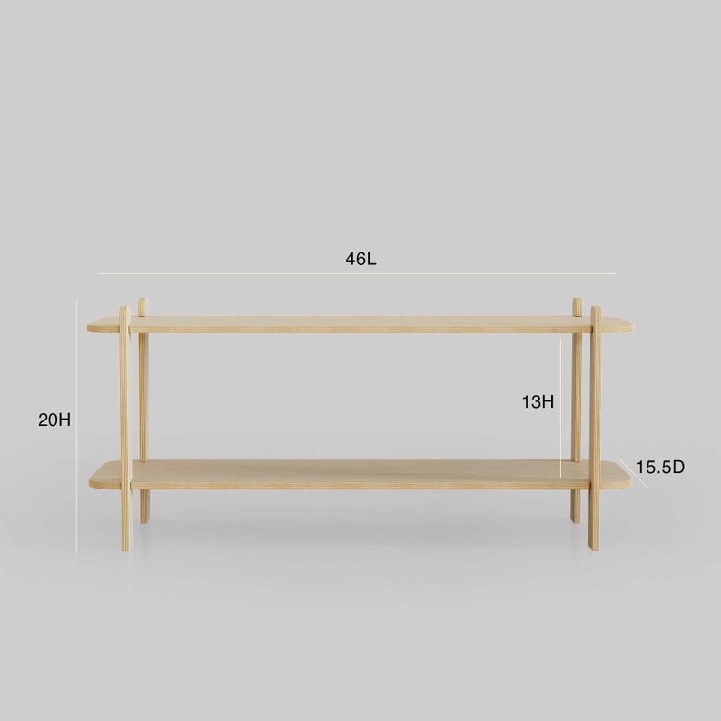 May include: A light-colored wooden shelf with two levels. The shelf is 46 inches long, 20 inches high, and 15.5 inches deep. The top shelf is 13 inches high. The design is minimalist and modern.