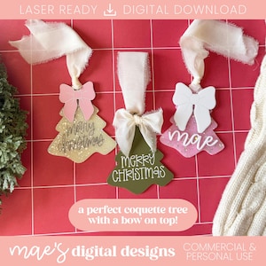 May include: Three Christmas tree ornaments with bows and ribbons. One is gold with a pink bow and the words "Merry Christmas". The second is green with a white bow and the words "Merry Christmas". The third is pink with a white bow and the word "mae".