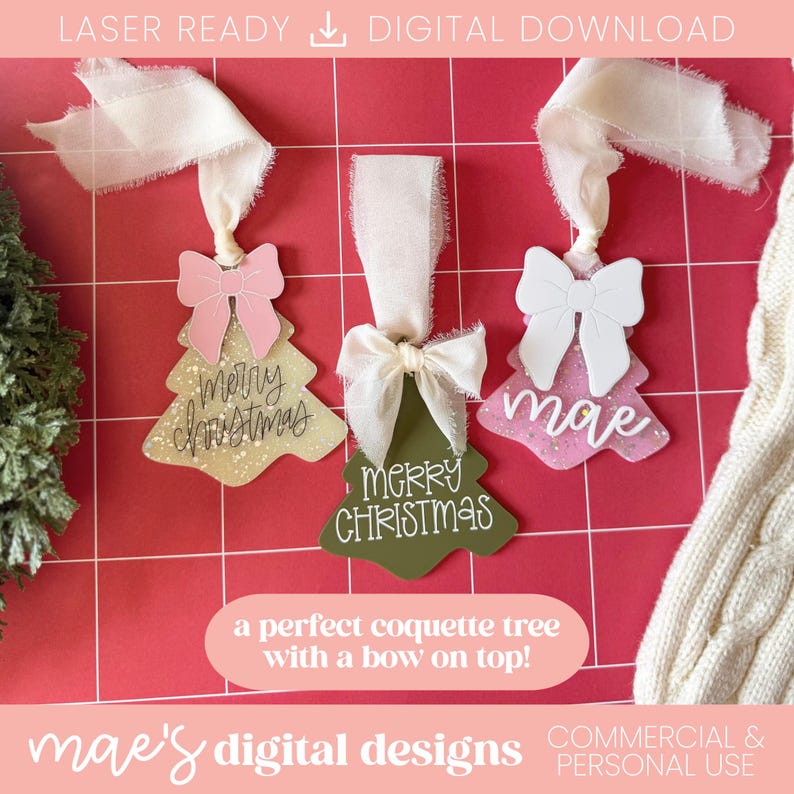May include: Three Christmas tree ornaments with bows and ribbons. One is gold with a pink bow and the words "Merry Christmas". The second is green with a white bow and the words "Merry Christmas". The third is pink with a white bow and the word "mae".
