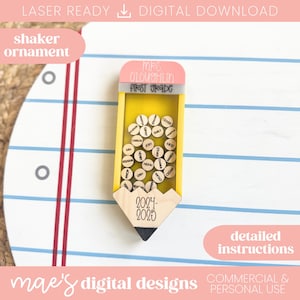 May include: A yellow pencil-shaped shaker ornament with a pink eraser top and a black pencil tip. The ornament contains small wooden circles with names. The text "MRS. OLOUSHLIN FIRST GRADE" is on the eraser. The year 2024-2025 is on the pencil.
