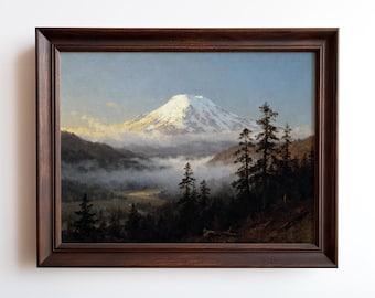 May include: A framed landscape painting depicts a snow-capped mountain rising above a valley filled with fog. Dark green trees line the foreground, and the painting is encased in a dark brown wooden frame.