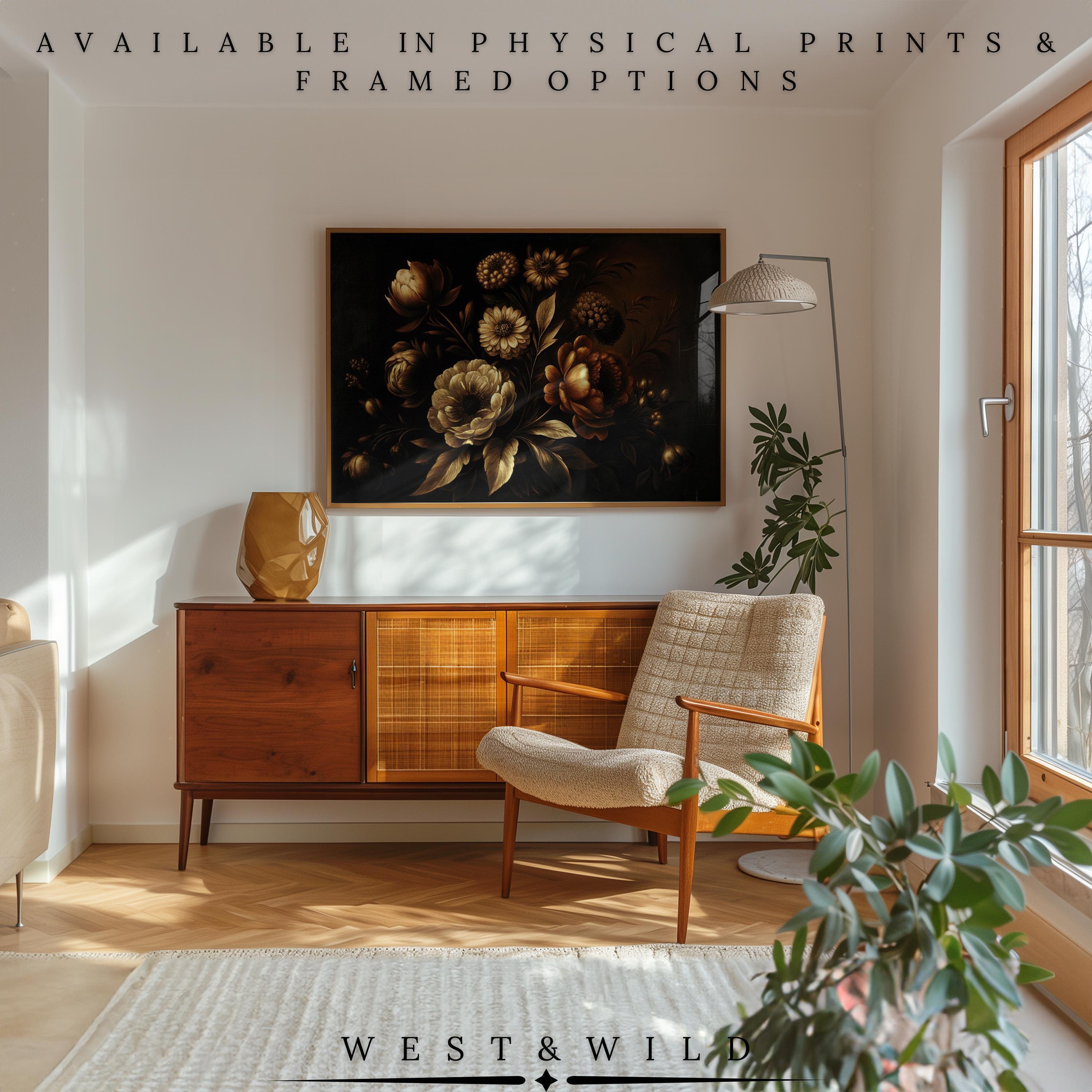 May include: A framed floral art print with a dark background hangs above a mid-century modern wooden cabinet. A beige armchair and a gold vase are in the room. The text "AVAILABLE IN PHYSICAL PRINTS & FRAMED OPTIONS" is at the top. The text "WEST & WILD" is at the bottom.