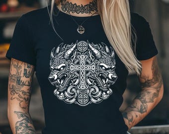 May include: Black t-shirt with a white graphic print of two wolf heads flanking a Celtic cross. The graphic is detailed and intricate, with a knotwork design.