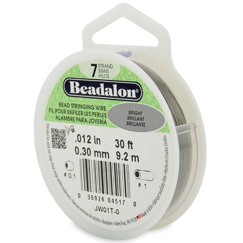 May include: A spool of 7-strand Beadalon bead stringing wire in silver. The wire is 0.012 inches (0.30 mm) thick and 30 feet (9.2 meters) long. The label reads "Beadalon Bead Stringing Wire" and "Bright Brilliant Brillante".