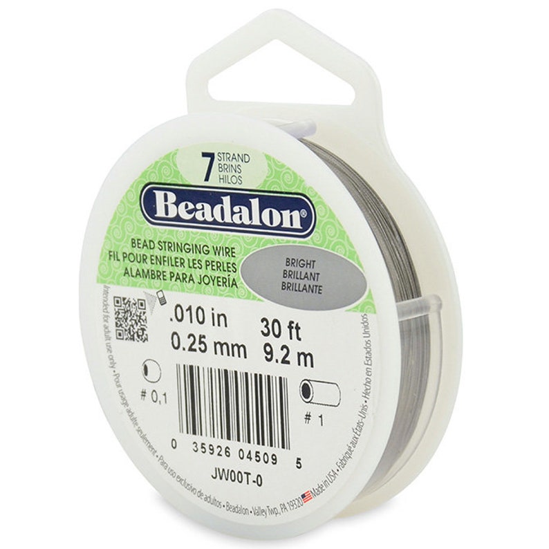 May include: A spool of 7-strand Beadalon bead stringing wire in silver. The wire is 0.010 inches (0.25 mm) thick and 30 feet (9.2 meters) long. The label reads "Beadalon Bead Stringing Wire, Bright, 30 ft, 9.2 m, JWOOT-0".