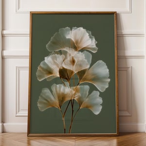May include: A framed art print depicting ginkgo leaves. The artwork displays translucent white and gold leaves against a dark green backdrop. The wooden frame complements the botanical illustration, adding a touch of nature to the design.