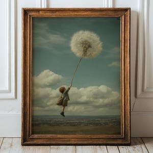 May include: A framed art print featuring a child holding a large dandelion seed head against a cloudy sky. The artwork has a vintage aesthetic with a brown wooden frame. The child is wearing a dress and appears to be floating.