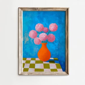 May include: A framed art print depicting pink flowers in an orange vase. The vase is on a checkered table against a textured blue backdrop. The artwork is presented in a wooden frame.