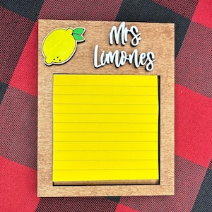 May include: A wooden framed notepad with a yellow sticky note and a lemon graphic. The notepad has the text "Mrs. Limones" written on it.