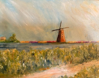 May include: An oil painting depicting a landscape with a brown windmill standing near a body of water. The foreground features a dirt path and green vegetation. In the distance, a small house sits near trees under a cloudy, light blue sky.