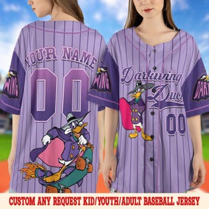 May include: Purple baseball jersey with vertical stripes, featuring the text "YOUR NAME" and the number "00" on the back. The front displays "Darkwing Duck" and the number "00". A cartoon character is on the front and back. The bottom text reads "CUSTOM ANY REQUEST KID/YOUTH/ADULT BASEBALL JERSEY".