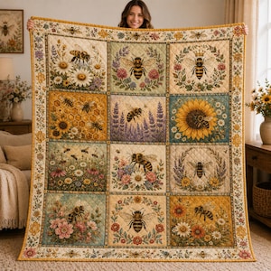 May include: A quilted throw blanket featuring a grid of twelve square panels, each displaying detailed illustrations of honeybees surrounded by various flowers, lavender sprigs, and honeycomb patterns in warm, earthy tones with a floral border.