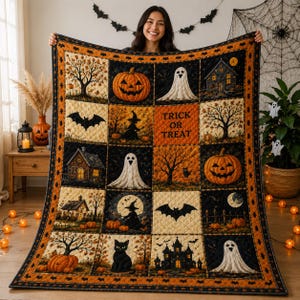 May include: A rectangular Halloween-themed quilt featuring a grid of sixteen squares with illustrations of pumpkins, ghosts, black cats, bats, haunted houses, and trees. The center square displays the text Trick or Treat in orange and black.