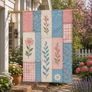 May include: A rectangular garden flag featuring a patchwork design of vertical panels in shades of pink, blue, and cream. The pattern includes polka dots, gingham checks, and various floral illustrations of stems, leaves, and individual blossoms.