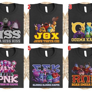 May include: Six black t-shirts with different designs featuring characters and Greek letters from the movie Monsters University. Each shirt has a unique design with text like "HSS ETA HISS HISS" and "OOZMA KAPPA".