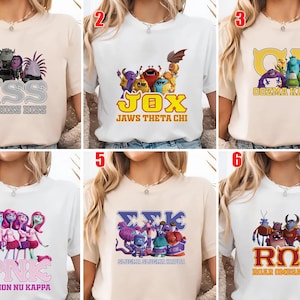 May include: A collection of six t-shirts, each featuring a different design with cartoon characters and text. The shirts are in various colors, including white and beige. The text includes phrases like "HSS ETA HISS HISS", "JOX JAWS THETA CHI", and "PNK PYTHON NU KAPPA".