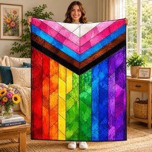 May include: A rectangular quilt featuring a vibrant, stained-glass inspired pattern with a chevron design at the top. The quilt displays a spectrum of colors including red, orange, yellow, green, blue, and purple, separated by bold black lines.
