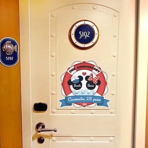 May include: A cream-colored door with a round porthole displaying the number 5192. A nautical-themed anniversary decoration features Mickey and Minnie Mouse heads, the names "Justin" and "Sarah", and the text "Celebrating 25 Years."