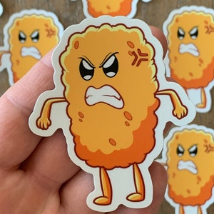 May include: A sticker featuring a cartoonish, anthropomorphic chicken nugget with an angry expression. The nugget is orange and brown with arms and legs, and a white border. Other similar stickers are visible in the background.