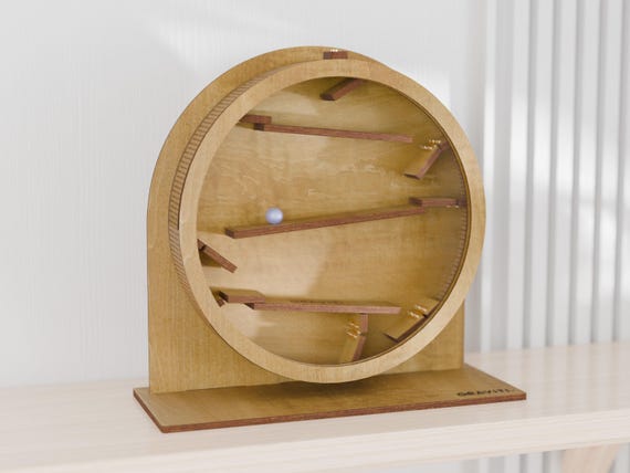 A hand-carved wooden marble run that sits on your desk and doubles as a mesmerizing kinetic sculpture — the kind of thing coworkers can't stop touching.