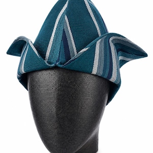 May include: Teal and white striped hat with a unique folded brim design. The hat is displayed on a black mannequin head. The hat's fabric has a textured appearance, and the stripes run vertically and diagonally across the crown and brim.