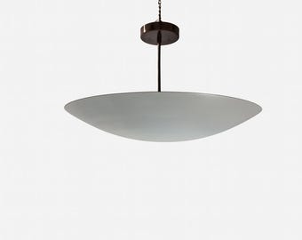 May include: A modern, hanging light fixture with a large, oval-shaped, frosted glass shade. The fixture is suspended from a dark brown metal rod and chain, attached to a circular ceiling mount. The design is minimalist and elegant.