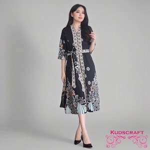 May include: A black midi dress with a floral pattern and a white belt. The dress has a V-neck and three-quarter sleeves.