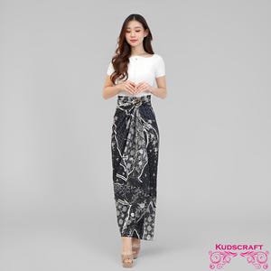 May include: A woman in a white top and a black and white patterned skirt. The skirt has a floral design and a gold-coloured buckle. The skirt is floor-length. The brand name "KUDSCRAFT" is in the bottom right corner.