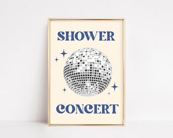 May include: A framed print with a cream background features a disco ball illustration. The words "SHOWER" and "CONCERT" are in blue, with blue star accents. The frame is gold.