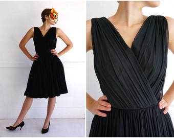 Chic Vintage 1960's Sleeveless Black Chiffon Cocktail Dress with Draped Crossover V Neckline and Full Skirt by R & K Originals | Small