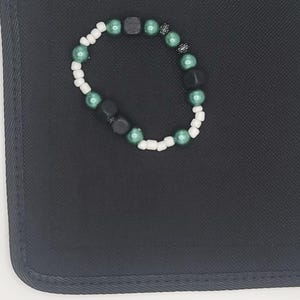 Handmade Bracelet with Green Pearls, Black Beads, and White Accents