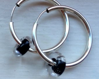 One pair of Sterling Silver-filled 28mm round hoop earrings with continuous closure.