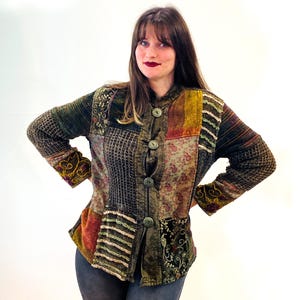 May include: A patchwork jacket with a variety of colors and textures, including green, brown, orange, and red. The jacket has a button-up front and long sleeves.