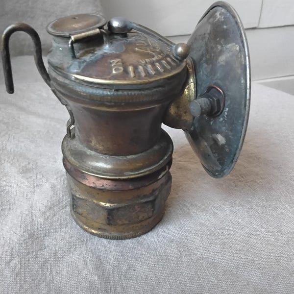 Antike Bergmanns Hartmetall Stirnlampe von Auto Lite.  Gutes Sammlerstück. Vermutlich aus den 1930er Jahren.  4 cm hoch, Schirm 3 cm breit.