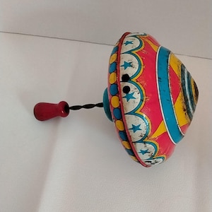 Vintage toy spinning top by Ohio Art.  Great zebra/circus litho.  Spins great.