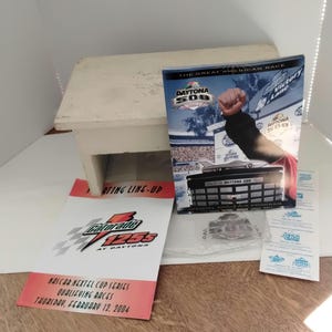 May include: Daytona 500 memorabilia including a souvenir programme, a Gatorade 125s at Daytona event programme, and other items. The programmes feature race details and event information.