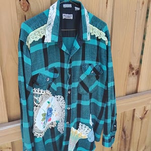 Upcycled flannel shirt size ladies XL.  Custom and unique. Cutely decorated with doilies, quilt patch and more.  Painted design on back