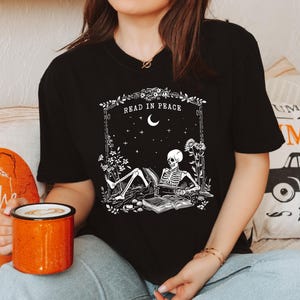 Read in Peace t-shirt, Skeleton Book Shirt, Skeleton Reading t-shirt, Book Lover Halloween, iprintasty Halloween, Bookish Halloween shirt