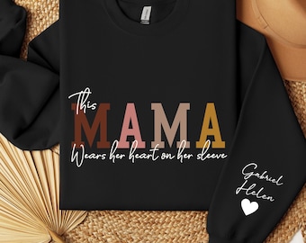 Custom This Mama Wears Her Heart On Her Sleeve Hoodie, Personalized Mom Sweatshirt With Kids Names, Momma Christmas Gift, Mothers Day Gifts