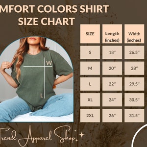Peut inclure: T-shirt Comfort Colors vert olive avec un tableau des tailles. Le tableau indique les tailles de S &agrave; 2XL, avec des mesures de longueur de 45,7 cm &agrave; 66 cm et de largeur de 67,3 cm &agrave; 80 cm. Le texte "Trend Apparel Shop" est en bas.