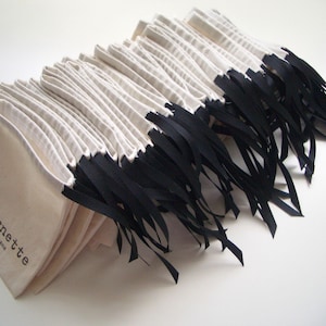 Custom printed 100% cotton pouches with grosgrain ribbon. Sustainable and Eco-friendly pouches made with Oeko-Tex cotton.