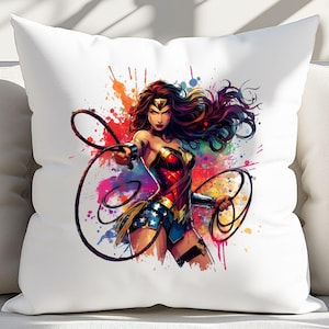 May include: White throw pillow featuring a vibrant illustration of Wonder Woman. The artwork showcases Wonder Woman in her iconic costume, with a dynamic pose and colorful paint splatter background. The pillow is a decorative item.