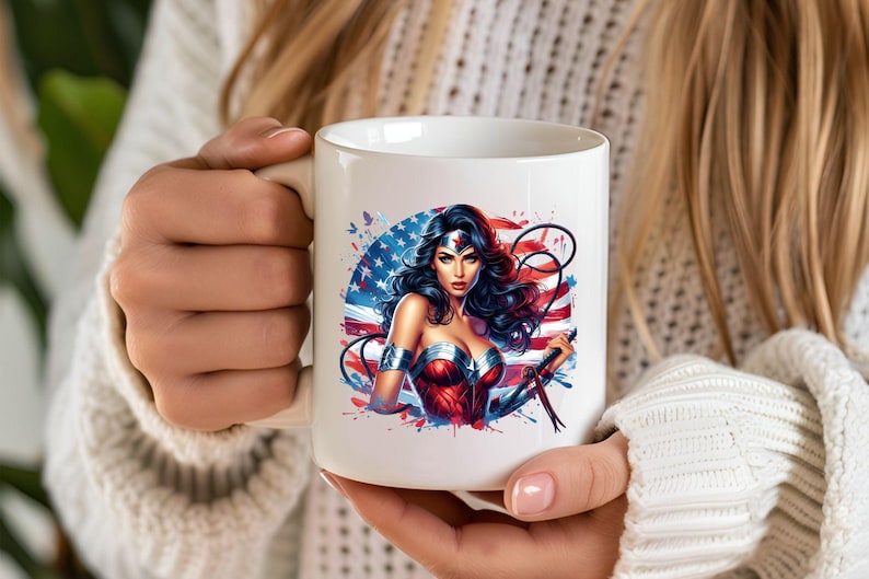 May include: White ceramic mug featuring a vibrant illustration of a superheroine with a patriotic theme. The design includes the American flag, stars, and a woman in a red and blue costume. The mug is held by a person.