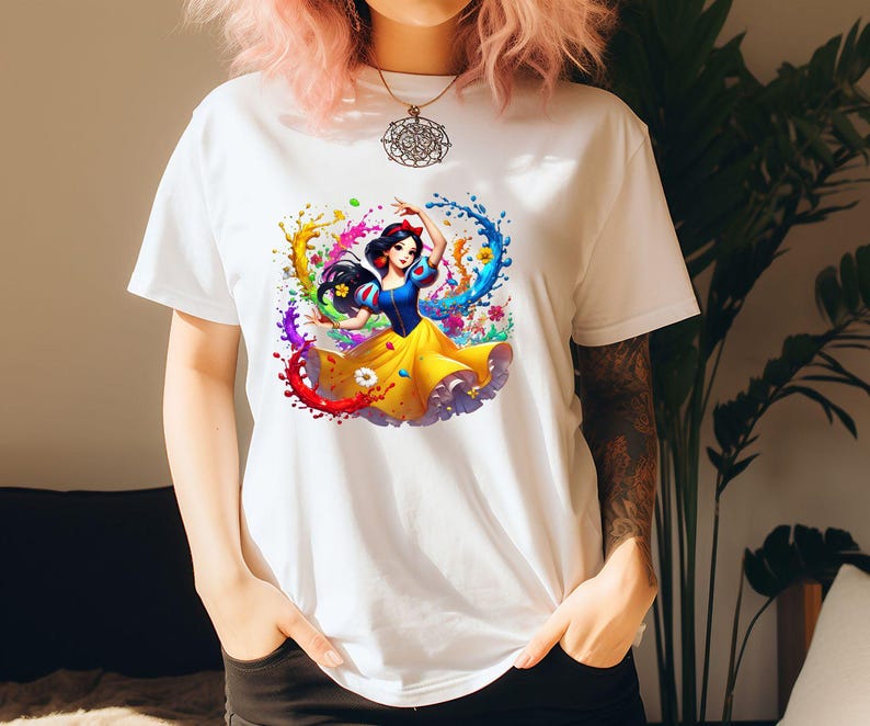 Op de afbeelding: Wit T-shirt met een kleurrijke afbeelding van Sneeuwwitje die danst in een wervelwind van verf.