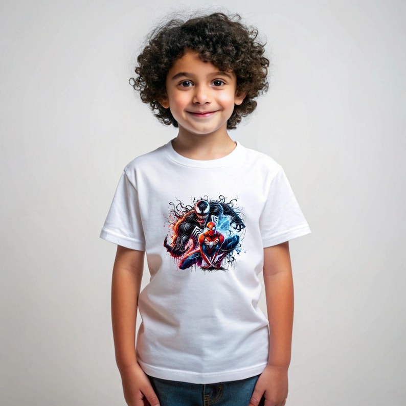 May include: A white t-shirt featuring a graphic print of Venom and Spider-Man in a dynamic pose. The print is in a black and red colour scheme with a splash of blue and white.