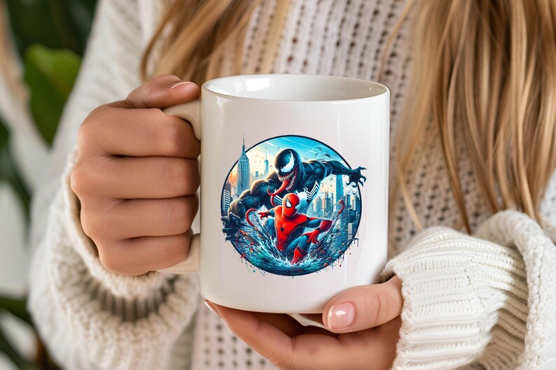 May include: White ceramic mug featuring a colourful illustration of Spider-Man and Venom battling in a city skyline. The mug has a black handle.