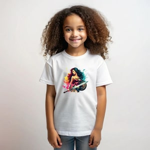 May include: White t-shirt featuring a colorful illustration of Wonder Woman with a sword and shield. The graphic includes splashes of yellow, pink, blue, and green. The shirt is short-sleeved and appears to be made of cotton.