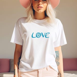 May include: White t-shirt with a blue graphic that says "LOVE" with a stylised swirl in the "O".