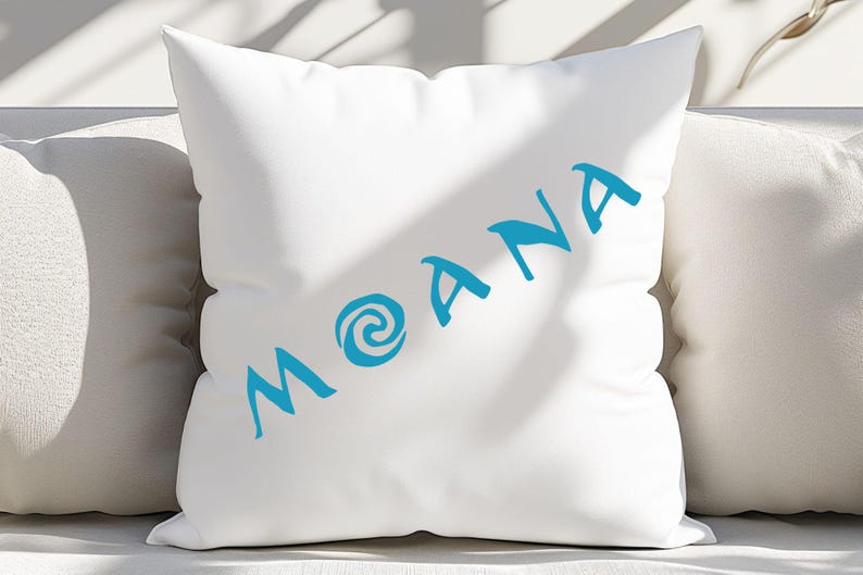May include: White pillow with a blue swirl design and the word "MOANA" written in blue cursive.