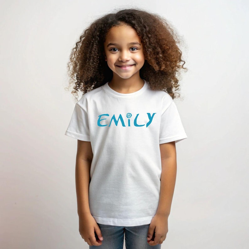May include: White t-shirt with a blue and teal "EMILY" graphic on the front.
